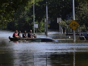 Rescue workers begin mandatory evacuations in the area beneath the Barker Reservoir as water is released after Hurricane Harvey caused widespread flooding in Houston, Texas on August 31, 2017.