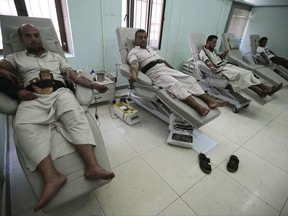 People donate blood in the National Blood Transfusion and Research Centre in Sanaa, Yemen, Wednesday, Aug. 9, 2017. The director of Yemen's national blood bank says the facility could shut down within a week after a medical aid charity ended its support. Ayman el-Shihari, the blood bank's general director, said Thursday its closure could lead to a "humanitarian catastrophe." (AP Photo/Hani Mohammed)