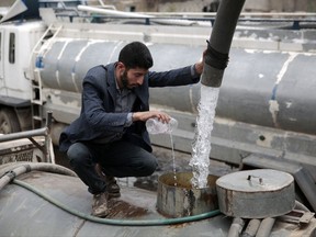 In this photo taken on Wednesday, Jul. 26, 2017, a man adds chlorine solution as he fills a tanker truck  with water from a water tap in Sanaa, Yemen. Yemen's raging two-year conflict has served as an incubator for lethal cholera. (AP Photo/Hani Mohammed)