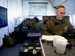 Joint Chiefs Chairman Gen. Joseph Dunford works in his private cabin aboard his plane, Saturday, Aug. 19, 2017, while traveling to Andrews Air Force Base, Md. (AP Photo/Andrew Harnik)