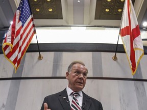 FILE - In this Wednesday, Aug. 9, 2017, file photo, U.S. Senate candidate Roy Moore holds a press conference in Montgomery, Ala. In the Alabama race for Attorney General Jeff Sessions' former Senate seat, the Republican slugfest primary is about love of all things Trump, with contenders openly wooing Trump voters, and hatred of the so-called swamp of Washington D.C. Sen. Luther Strange, who was appointed to the position in February, is trying to fight off a field of firebrand challengers, including U.S. Rep. Mo Brooks and Moore in the GOP primary. (Mickey Welsh/The Montgomery Advertiser via AP, File)