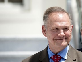 FILE - In this April 26, 2017 file photo, former Alabama Chief Justice Roy Moore smiles before announcing his candidacy for U.S. Senate in Montgomery, Ala. Moore, who was twice removed from his duties after losing battles on gay marriage and the public display of the Ten Commandments, is in a heated Republican primary with incumbent Sen. Luther Strange and Congressman Mo Brooks. (Albert Cesare/The Montgomery Advertiser via AP, File)