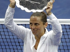 FILE - In this  Saturday, Sept. 12, 2015 file photo Roberta Vinci, of Italy, holds the finalist's trophy after she was beaten by Flavia Pennetta, of Italy, in the women's championship match of the U.S. Open tennis tournament, in New York. Former U.S. Open runner-up Roberta Vinci said her tennis trophies have been stolen, writing on Instagram, "Unfortunately, a few days ago a group of thieves entered my house in Taranto and stole valuable objects. (AP Photo/Seth Wenig. File)