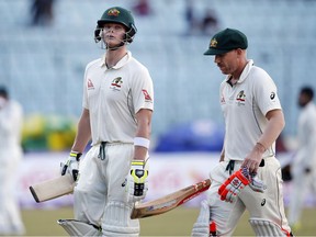 Australian cricket team captain Steve Smith, left, and his teammate David Warner leave the ground after end of the third day of the first test cricket match against Bangladesh in Dhaka, Bangladesh, Tuesday, Aug. 29, 2017. (AP Photo/A.M. Ahad)