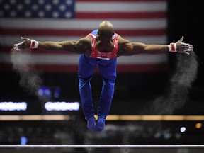 Donnell Whittenburg releases while working on the high bar at the USA Gymnastics championships, Thursday, Aug. 17, 2017, in Anaheim, Calif. (AP Photo/Mark J. Terrill)