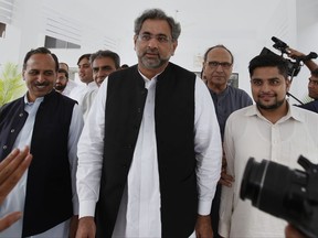 Pakistan's premier-designate Shahid Khaqan Abbasi, center, leaves with his aids after meeting with politicians in Parliament house in Islamabad, Pakistan, Monday, July 31, 2017. Pakistan's parliament will meet Tuesday to elect a new prime minister after the disqualification of three-term prime minister Nawaz Sharif. Sharif's Pakistan Muslim League party nominated Sharif's longtime loyalist Abbasi for the top slot on Saturday. (AP Photo/Anjum Naveed)