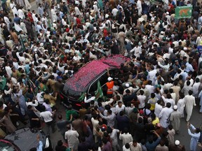 The vehicle of deposed Prime Minister Nawaz Sharif is surrounded by his supporters during a rally in Islamabad, Pakistan, Wednesday, Aug. 9, 2017. Pakistan's deposed prime minister Sharif began two days of rallies Wednesday in a move aimed at demonstrating his political strength, making stops from the capital Islamabad to his hometown of Lahore, ignoring security threats. (AP Photo/ Anjum Naveed)