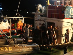 The Iuventa Ship of the German NGO Jugend Rettet is docked at Lampedusa' harbor, Italy, early Wednesday, Aug. 2, 2017.  The German NGO migrant rescue boat has been put under preventive seizure in a Sicilian island port as Italian authorities investigate what they suspected could be aiding "clandestine immigration."  (Elio Desiderio/ANSA via AP)