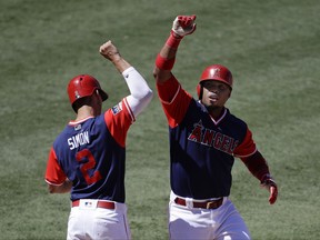 Los Angeles Angels' Luis Valbuena, right, celebrates his two-run home run with Andrelton Simmons during the sixth inning of a baseball game against the Houston Astros, Sunday, Aug. 27, 2017, in Anaheim, Calif. (AP Photo/Jae C. Hong)