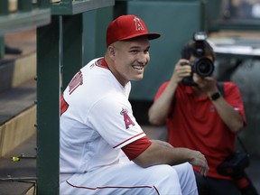 Los Angeles Angels' Mike Trout smiles while chatting with teammates in the dugout before the team's baseball game with the Baltimore Orioles, Monday, Aug. 7, 2017, in Anaheim, Calif. (AP Photo/Jae C. Hong)