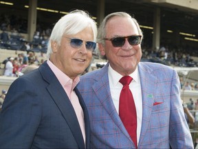 In a photo provided by Benoit Photo, owner Peter Fluor, right, celebrates with trainer Bob Baffert, left, after Collected's victory in the Grade I, $1 million TVG Pacific Classic horse race, Saturday, Aug. 19, 2017, at Del Mar Thoroughbred Club in Del Mar, Calif. (Benoit Photo via AP)