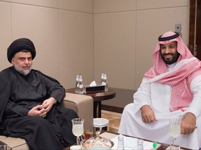 In this Monday, July 31, 2017 photo, released by Saudi Press Agency, Saudi Crown Prince and Minister of Defense Mohammed bin Salman, right, receives Iraqi Shiite cleric Muqtada al-Sadr in Jeddah, Saudi Arabia. Al-Sadr, notorious for his followers' deadly attacks on U.S. troops in Iraq and long-thought to be close to Iran, is now cultivating ties with Saudi Arabia and the United Arab Emirates, two Sunni nations among Arab Gulf states that are fiercely critical of Tehran. (Saudi Press Agency via AP)