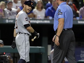 Detroit Tigers' Ian Kinsler, left, argues with crew chief Ted Barrett, right, after Kinsler was ejected by home plate umpire Angel Hernandez in the fifth inning of a baseball game against the Texas Rangers on Monday, Aug. 14, 2017, in Arlington, Texas. (AP Photo/Tony Gutierrez)