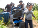 Asylum seekers cross the Canadian border into Quebec in early August.