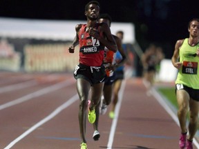 Mohammed Ahmed crosses the finish line to win the 5,000 metres at the national championships in Ottawa on July 6.