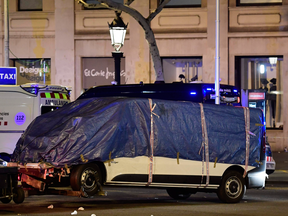 The van that was driven into a crowd in Barcelona, killing at least 13 people and injuring around 100, is towed away on Aug. 18, 2017.