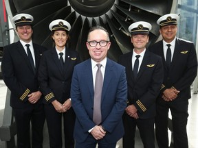 Alan Joyce, chief executive officer of Qantas Airways Ltd., center, poses for a photograph with the company's pilots and co-pilots in Sydney, Australia, on Friday, Aug. 25, 2017. Qantas hopes to offer a direct flight from Sydney to London by 2020.