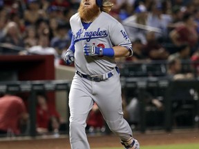 Los Angeles Dodgers' Justin Turner rounds the bases after hitting a solo home run against the Arizona Diamondbacks during the sixth inning of a baseball game, Tuesday, Aug. 8, 2017, in Phoenix. (AP Photo/Matt York)