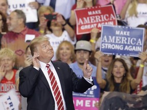 President Donald Trump gestures to the crowd while speaking at a rally at the Phoenix Convention Center, Tuesday, Aug. 22, 2017, in Phoenix. (AP Photo/Rick Scuteri)