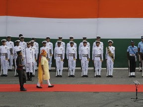 Indian Prime Minister Narendra Modi walks to inspect a guard of honor before addressing the nation from the ramparts of Red Fort to celebrate Independence Day in New Delhi, India, Tuesday, Aug. 15, 2017. India commemorated its Independence in 1947 from British colonial rule, on Aug. 15. (AP Photo/Manish Swarup)