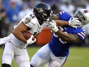 Baltimore Ravens wide receiver Michael Campanaro, left, tries to outrun Buffalo Bills linebacker Ramon Humber as he rushes the ball in the first half of a preseason NFL football game, Saturday, Aug. 26, 2017, in Baltimore. (AP Photo/Gail Burton)