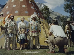 A man takes a photo during Banff Indian Days, 1957