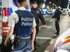 Policemen stand guard the Boulevard Emile Jacqmain in the city centre of Brussels on Aug. 25, 2017