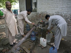 People collect water at a tube well in Islamabad, Pakistan, Wednesday, Aug. 23, 2017. A new study suggests some 50 million Pakistanis could be at risk of drinking arsenic-tainted groundwater. The findings are based on a hazard map built using water quality data from 1,200 tube wells in the densely populated Indus Valley. (AP Photo/B.K. Bangash)