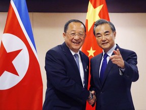 FILE - In this Aug. 6, 2017, file photo, North Korean Foreign Minister Ri Yong Ho, left, is greeted by his Chinese counterpart Wang Yi prior to their bilateral meeting in the sidelines of the 50th ASEAN Foreign Ministers' Meeting and its Dialogue Partners in suburban Pasay city, south Manila, Philippines. China's patience with its onetime close ally appears to be running thin: China agreed to recent U.N. sanctions, despite potential losses to Chinese firms doing business with North Korea and fears over destabilizing the Pyongyang regime. (AP Photo/Bullit Marquez, File)
