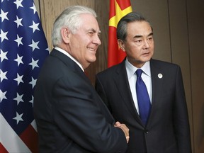 U.S. Secretary of State Rex Tillerson, left, and  China's Foreign Minister Wang Yi pose for a photograph during their bilateral meeting on the sidelines of the 50th Association of Southeast Asian Nations (ASEAN) Regional Forum (ARF) in Manila, Philippines on Sunday.