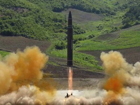 FILE - This file photo distributed by the North Korean government shows what was said to be the launch of a Hwasong-14 intercontinental ballistic missile, ICBM, in North Korea's northwest, Tuesday, July 4, 2017. Donald Trump's threat to unleash "fire and fury" on North Korea might have been written by Pyongyang's propaganda mavens, so perfectly does it fit the North's cherished claim that it is a victim of American aggression. (Korean Central News Agency/Korea News Service via AP, File)