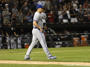 Toronto Blue Jays relief pitcher Roberto Osuna (54) walks back to the mound after giving up an RBI single to Chicago White Sox's Jose Abreu (79) during the ninth inning of a baseball game, Monday, July 31, 2017, in Chicago.