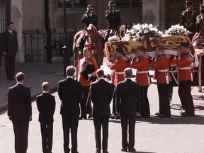 In this Sept. 6, 1997 photo, Britain's Prince Charles, Prince Harry, Earl Charles Spencer, Prince William and Prince Philip, from left, stand as the coffin bearing the body of Princess Diana is taken into Westminster Abbey in London.