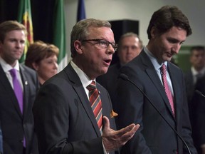 Prime Minister Justin Trudeau listens as Saskatchewan Premier Brad Wall responds to a question during a First Ministers meeting at the Canadian Museum of Nature in Ottawa on Monday, Nov. 23, 2015.