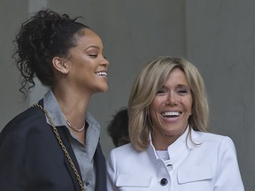 Singer Rihanna, left, and Brigitte Macron, the wife of French President Emmanuel Macron walk out of the Elysee Palace after a meeting in Paris, France, Wednesday, July 26, 2017.