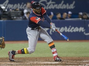 Minnesota Twins' Byron Buxton delivers an RBI single against the Toronto Blue Jays in MLB action Friday night at Rogers Centre.  Buxton was a standout both offensively and defensively in a 6-1 Twins victory.