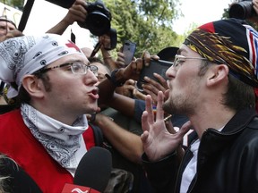 A counterprotester, left, confronts a supporter of President Donald Trump at a "Free Speech" rally by conservative activists on Boston Common, Saturday, Aug. 19, 2017, in Boston. Thousands of  counterprotesters marched through downtown Boston on Saturday, chanting anti-Nazi slogans and waving signs condemning white nationalism ahead of a rally being staged by conservative activists a week after a Virginia demonstration turned deadly.   (AP Photo/Michael Dwyer)
