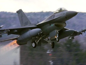 FILE-- In this Dec. 2001 file photograph, an F-16 takes off with afterburners glowing loaded with live Sidewinder missiles from the Air National Guard base in South Burlington, Vt.  A National Guard proposal to expand airspace for fighter jet training flights low over the mountains of western Maine has dragged on for so long that many of the aircraft could be retired around the time the process is completed.  (AP Photo/Toby Talbot)
