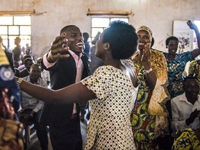 In this June 7th, 2017 photo provided by Alex Buisse, students, family and friends celebrate after the first class of the Southern New Hampshire University and Kepler higher education program graduated in Kiziba Refugee Camp in Kigali, Rwanda. The New Hampshire university has set an ambitious goal of enrolling 50,000 refugees from around the world in its accredited degree programs by 2022. (Alex Buisse via AP)