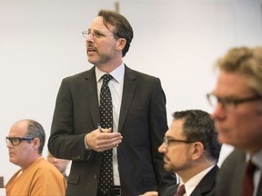 FILE - Int his July 5, 2017 file photo, Assistant public defender Scott Sanders questions Orange County Sheriff Sandra Hutchens about the use of jailhouse informants during an evidentiary hearing for convicted murderer Scott Dekraai, left, at the Santa Ana Central Justice Center in Santa Ana, Calif.  Judge Thomas Goethals is weighing whether Dekraai should be spared the death penalty due to a long-running scandal over authorities' use of jailhouse informants. Goethals is expected to rule Friday, Aug. 18 on whether Dekraai should remain eligible for the death penalty or sentenced to life without parole for killing eight people in a 2011 shooting rampage at an Orange County hair salon. Sanders began asking questions about the use of jailhouse informants after noticing the same snitch had chattered up Dekraai and another one of his clients.  (Nick Agro /The Orange County Register via AP, File)