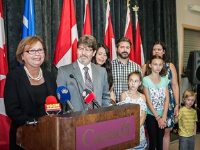 Public Works Minister Judy Foote addresses a news conference in St.John's, N.L on Thursday, Aug.24, 2017 as family members look on. Foote announced Thursday that she's resigning immediately from the federal cabinet and will step down as a Liberal MP shortly after Parliament resumes next month.