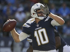Los Angeles Chargers quarterback Kellen Clemens looks for a receiver, against the New Orleans Saints during the first half of an NFL preseason football game Sunday, Aug. 20, 2017, in Carson, Calif. (AP Photo/Jae C. Hong)