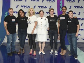 Sarah Kate Ellis, GLADD president and CEO, third from left, and transgender service members arrive at the MTV Video Music Awards at The Forum on Sunday, Aug. 27, 2017, in Inglewood, Calif. (Photo by Jordan Strauss/Invision/AP)