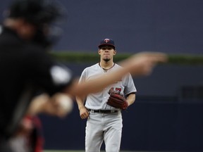 Home plate umpire Ron Kulpa calls a strike as Minnesota Twins starting pitcher Jose Berrios waits for the ball while pitching against a San Diego Padres batter during the first inning of a baseball game Tuesday, Aug. 1, 2017, in San Diego. (AP Photo/Gregory Bull)