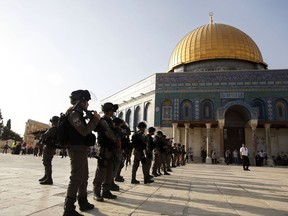 FILE - In this Thursday, July 27, 2017, file photo, Israeli border police officers stand near the Dome of the Rock Mosque in the Al Aqsa Mosque compound in Jerusalem's Old City.   Jordan's king flew by helicopter to the West Bank on Monday -- a rare visit seen as a signal to Israel that he is closing ranks with the Palestinians on key issues, such as a contested Jerusalem shrine. (AP Photo/Mahmoud Illean, File)