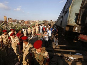 Army attend the scene of a train collision just outside Egypt's Mediterranean port city of Alexandria, Friday, Aug. 11, 2017, two trains collided killing dozens of people and injuring over 100 in the country's deadliest rail accident in more than a decade. (AP Photo/Ravy Shaker)