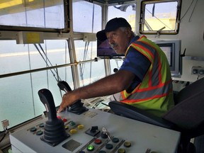 In this Wednesday, Aug. 9, 2017 photo, a port employee trains on a container crane in the port of the northern city of Tripoli, Lebanon. Markets across the Middle East are anticipating a mammoth reconstruction boom in Syria that could stimulate billions of dollars in economic activity, and Lebanon, as Syria's neighbor, is in prime position to capture a share of that reward.(AP Photo/Bilal Hussein)