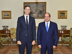 In this photo provided by Egypt's state news agency, MENA, Egypt's President Abdel-Fattah el-Sissi, right, poses for a photo with White House adviser Jared Kushner, in Cairo, Egypt, Wednesday, Aug. 23, 2017. El-Sissi and Egypt's foreign minister have met with Kushner just hours after the Trump administration cut or delayed hundreds of millions of dollars in aid to Cairo over human rights concerns. Kushner, who is also President Donald Trump's son-in-law, was in Cairo as part of a Middle East tour aimed at exploring ways to revive Israeli-Palestinian peace talks, which last collapsed in 2014. (MENA via AP)