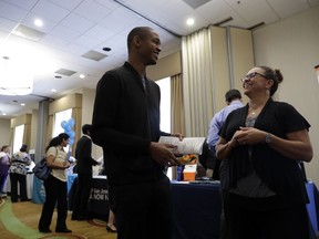 In this Thursday, Aug. 24, 2017, photo, Kathy Tringali, right, a recruiter for Big 5 Sporting Goods, talks to job seeker Jarrell Palmer during a job fair, in San Jose, Calif. On Wednesday, Aug. 30, 2017, the Commerce Department issues the second of three estimates of how the U.S. economy performed in the April-June quarter. (AP Photo/Marcio Jose Sanchez)