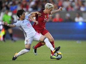 Japan's Yuka Momiki, left, and United States' Megan Rapinoe vie for the ball during the first half of Tournament of Nations soccer match, Thursday, Aug. 3, 2017, in Carson, Calif. (AP Photo/Mark J. Terrill)